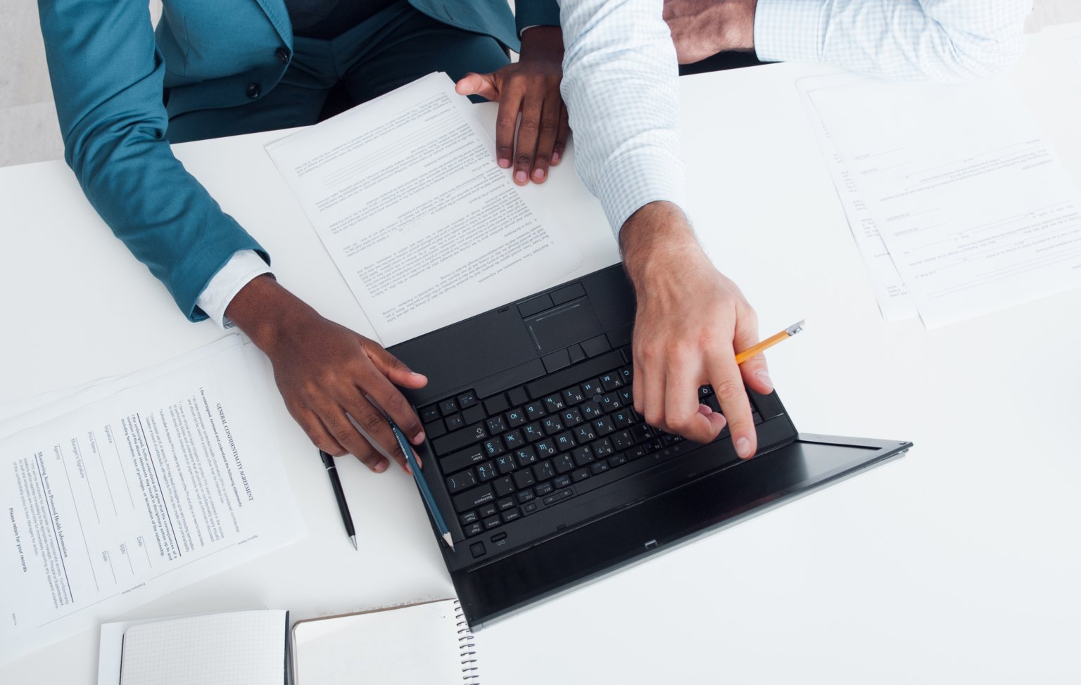 Two professionals reviewing documents and discussing data on a laptop-Career Coach Arlington VA