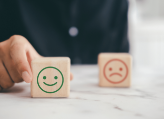 a happy face block in front of a sad face block to depict career transition Counseling